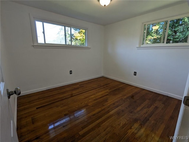 unfurnished room featuring dark hardwood / wood-style flooring