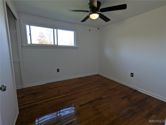 unfurnished room with ceiling fan and dark hardwood / wood-style flooring