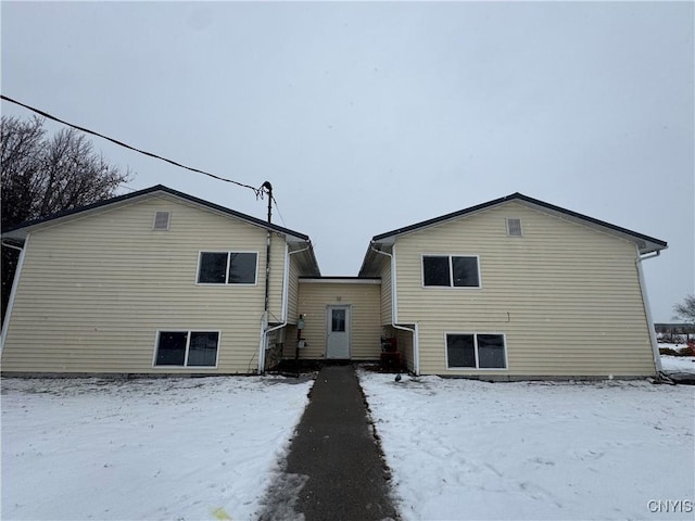 view of snow covered rear of property