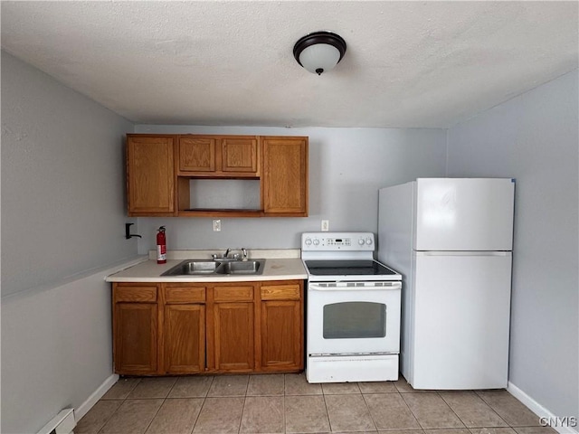 kitchen featuring baseboard heating, white appliances, a textured ceiling, sink, and light tile patterned floors