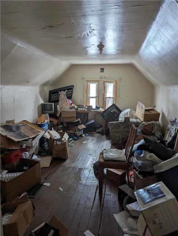 additional living space featuring lofted ceiling and hardwood / wood-style flooring