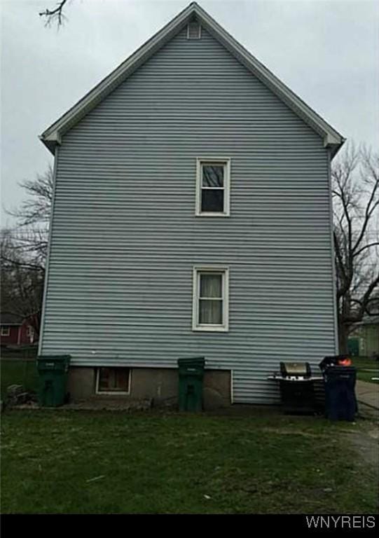 view of property exterior featuring a lawn