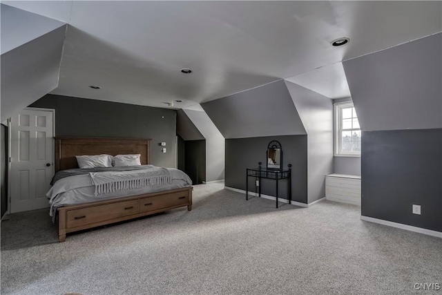 bedroom featuring light colored carpet and vaulted ceiling