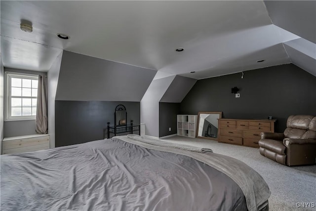 carpeted bedroom with lofted ceiling