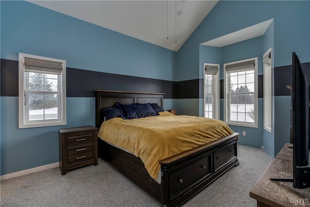 bedroom featuring light carpet and vaulted ceiling