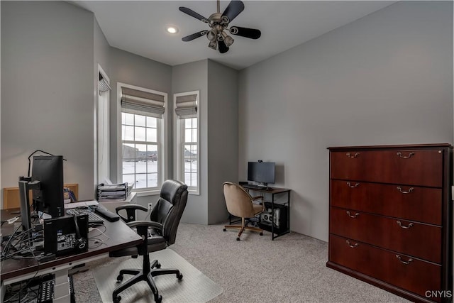 office space with ceiling fan and light colored carpet