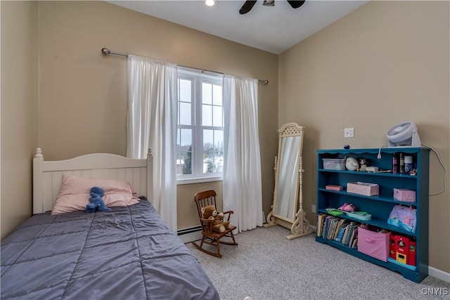 carpeted bedroom featuring ceiling fan and baseboard heating