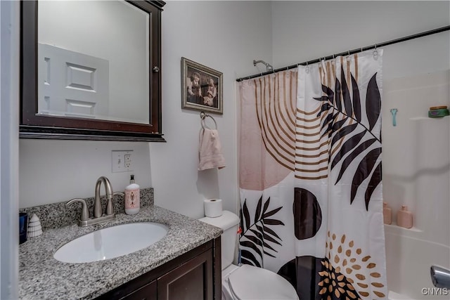 bathroom with toilet, vanity, and a shower with shower curtain