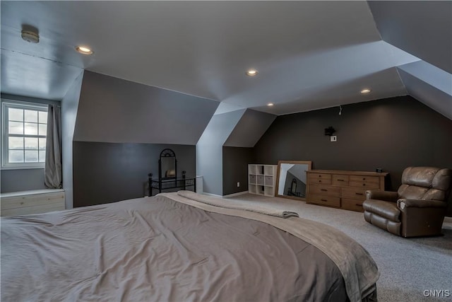 bedroom with vaulted ceiling and carpet flooring