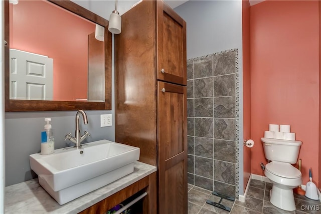 bathroom featuring tile patterned floors, toilet, and vanity