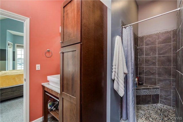 bathroom featuring curtained shower and vanity