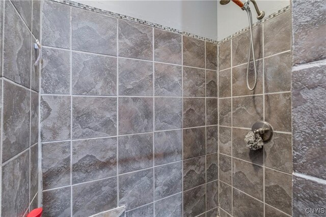 bathroom with tiled shower