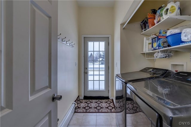 washroom featuring baseboard heating, light tile patterned floors, and washer and clothes dryer