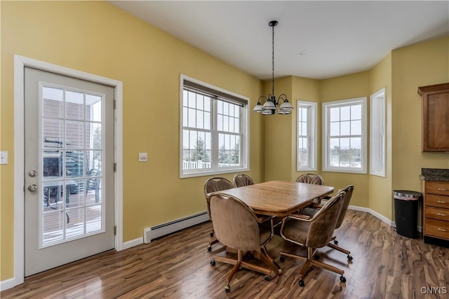 dining room featuring baseboard heating, dark hardwood / wood-style flooring, and a notable chandelier