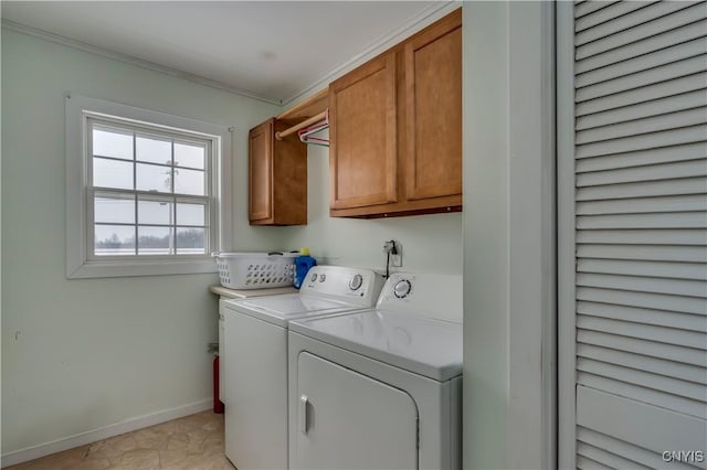 laundry area featuring cabinets, separate washer and dryer, and ornamental molding