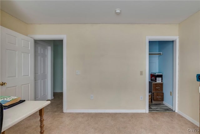 bedroom with light carpet and a closet