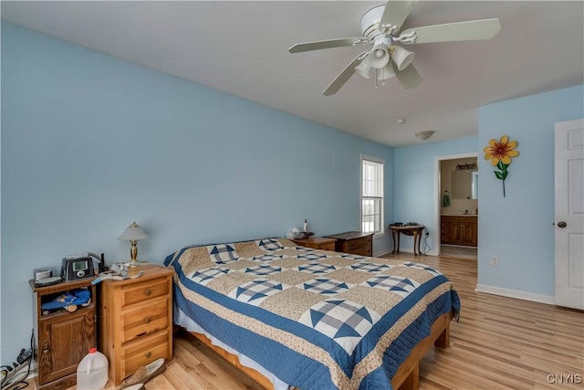 bedroom featuring ceiling fan, light hardwood / wood-style floors, and ensuite bathroom