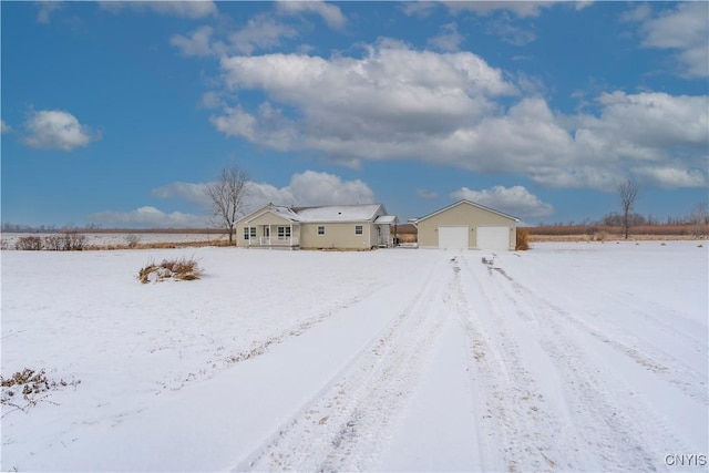 yard covered in snow featuring a garage