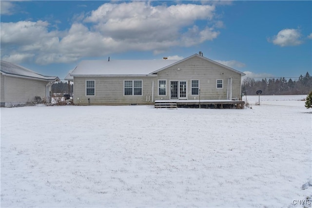 view of snow covered back of property