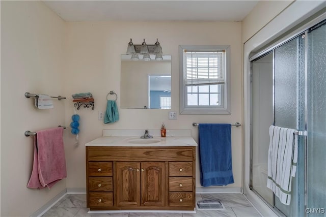 bathroom with walk in shower and vanity