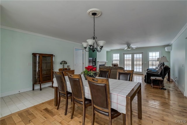 dining area featuring french doors, crown molding, ceiling fan with notable chandelier, and light hardwood / wood-style flooring