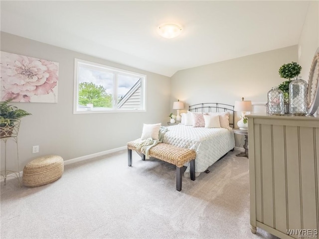 carpeted bedroom featuring vaulted ceiling