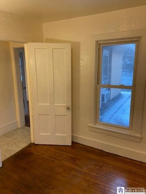 unfurnished bedroom featuring dark wood-type flooring