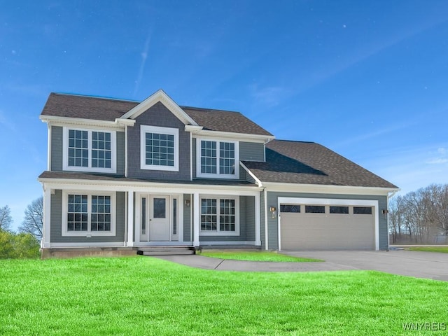 view of front of house featuring a garage, a front lawn, and covered porch