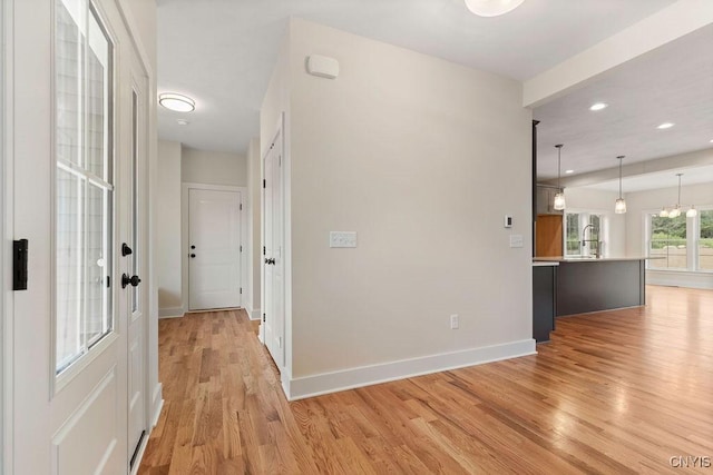 corridor with light hardwood / wood-style floors