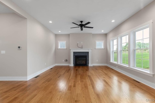 unfurnished living room with ceiling fan and light hardwood / wood-style flooring