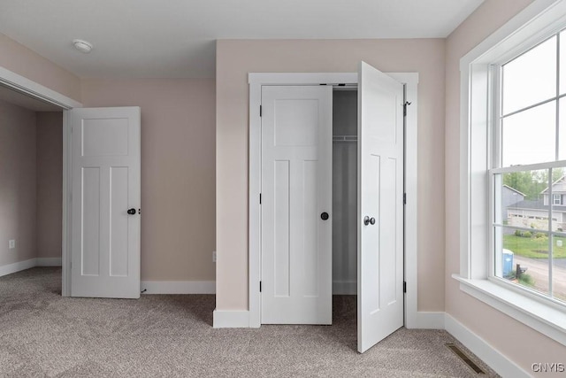 unfurnished bedroom with light colored carpet