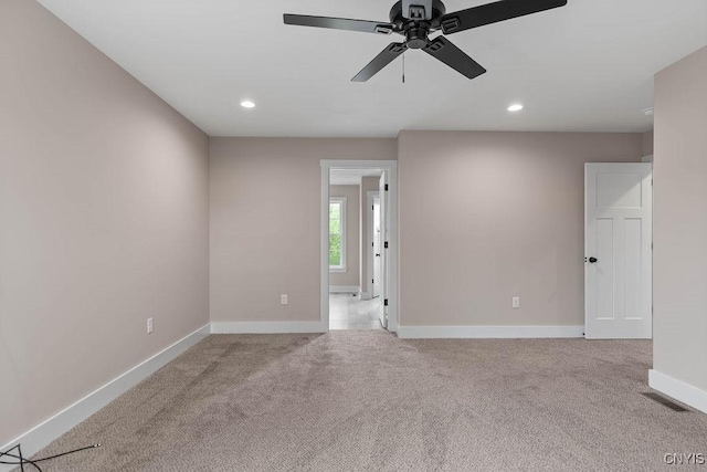 carpeted empty room with ceiling fan