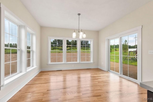 unfurnished sunroom with an inviting chandelier