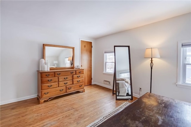 interior space with light hardwood / wood-style floors and vaulted ceiling