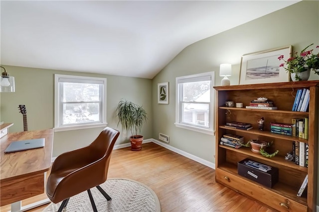 office area with vaulted ceiling and light hardwood / wood-style flooring