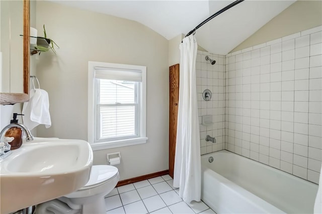 full bathroom with tile patterned floors, shower / bath combination with curtain, sink, toilet, and vaulted ceiling