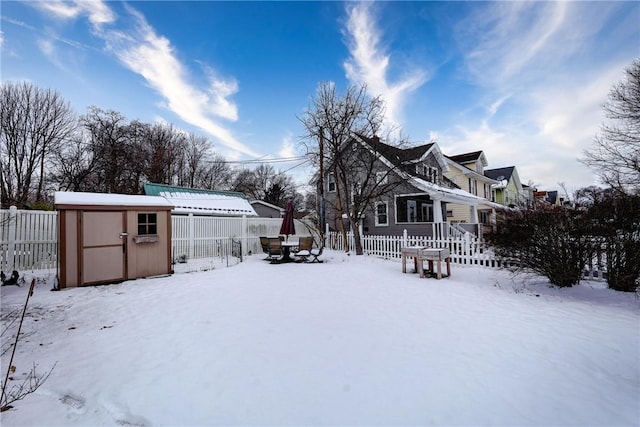 snowy yard with a shed