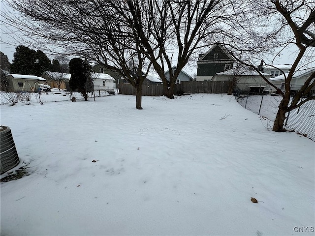 yard covered in snow featuring central AC