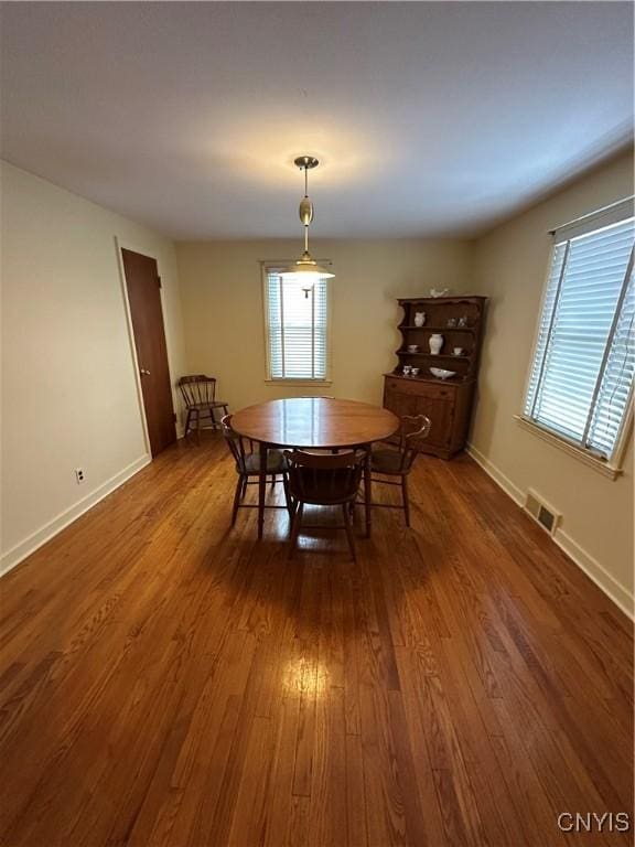 dining space with dark wood-type flooring