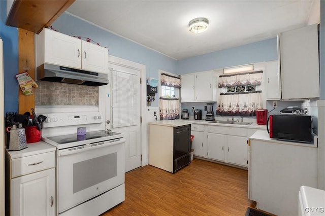 kitchen with electric stove, white cabinets, and sink