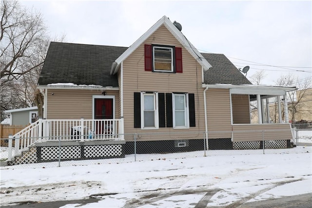 view of snow covered rear of property