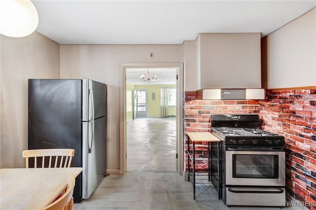 kitchen with an inviting chandelier and appliances with stainless steel finishes