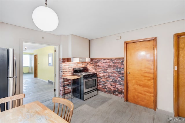 kitchen featuring appliances with stainless steel finishes and pendant lighting