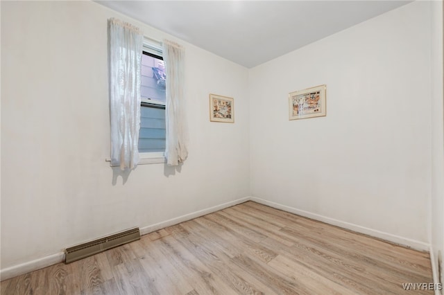 spare room with light hardwood / wood-style flooring