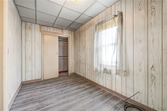 unfurnished bedroom featuring hardwood / wood-style flooring and a paneled ceiling