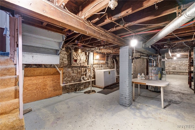 basement with washer and clothes dryer and gas water heater