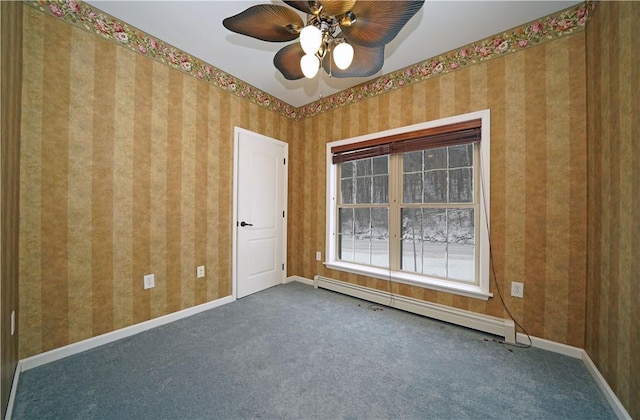 carpeted empty room featuring ceiling fan and a baseboard radiator