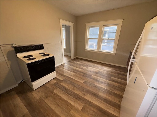 kitchen with white fridge, dark hardwood / wood-style flooring, and electric range