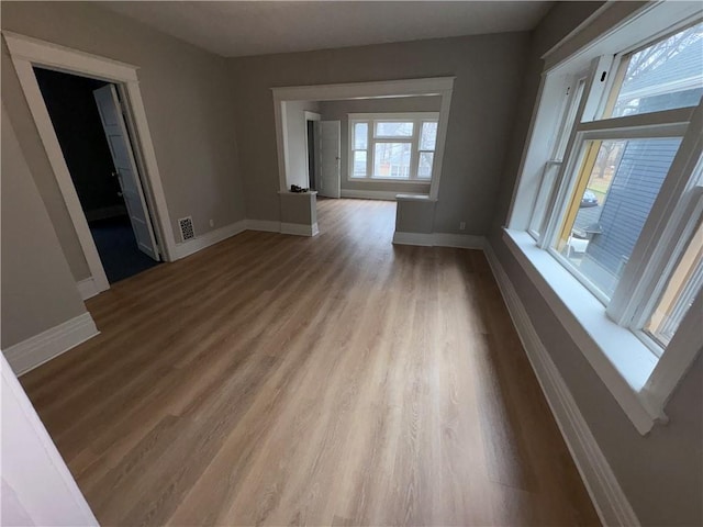 empty room with light hardwood / wood-style flooring