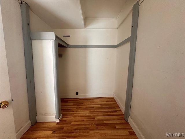 corridor featuring hardwood / wood-style floors